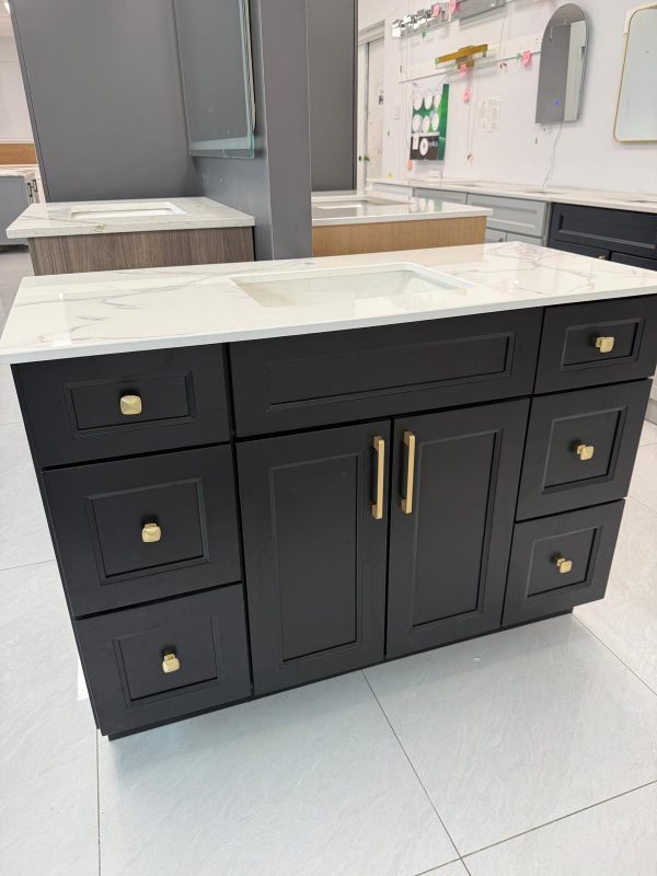 Black bathroom vanity with gold handles and marble countertop by Supply Toronto