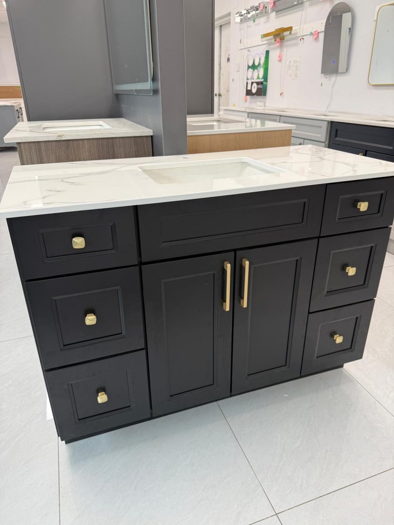 Black bathroom vanity with gold handles and marble countertop by Supply Toronto