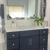 LED mirror Toronto installed above navy blue bathroom vanity — Supply Toronto