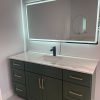 LED mirror above green bathroom vanity with quartz countertop Toronto — Supply Toronto