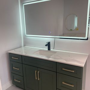 LED mirror above green bathroom vanity with quartz countertop Toronto — Supply Toronto