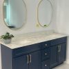 Prussian blue bathroom vanity with gold handles and round mirror by Supply Toronto