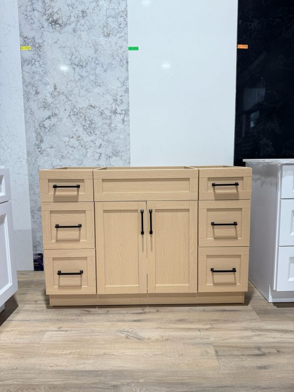 Light oak veneer bathroom vanity cabinet with matte black handles and shaker drawer fronts at Supply Toronto showroom